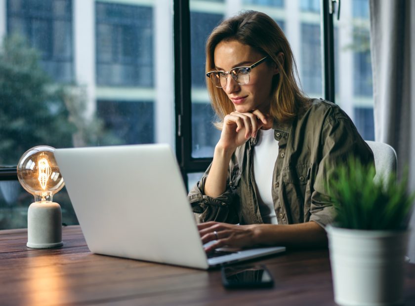 Young woman working with a laptop. Female freelancer connecting